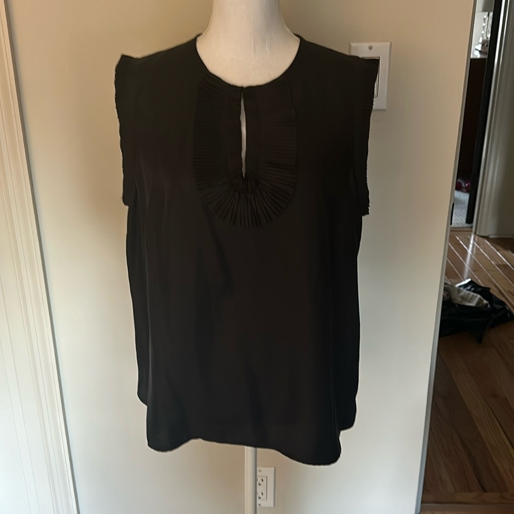 Classic Sleeveless silk like shell with keyhole neck and pleated/ruffle detail!